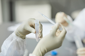 Side view portrait of young black woman wearing protective gear while working in research laboratory