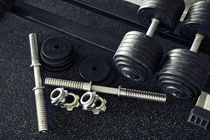 High angle view of metal details and dumbbells for sport training in gym