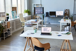 Workplace of manager or chief executive officer of modern company with laptop and supplies on background of other desks