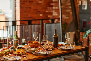 Warm toned background image of wooden dinner table served for cozy cabin party, copy space