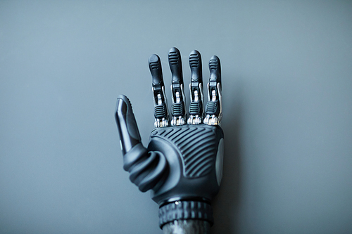 Close-up of prosthetic arm for people with disability isolated on blue background