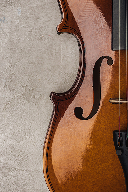 top view of classical cello on grey textured surface