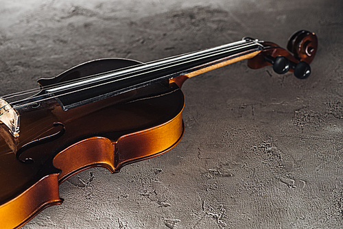 classical violoncello in darkness on textured surface