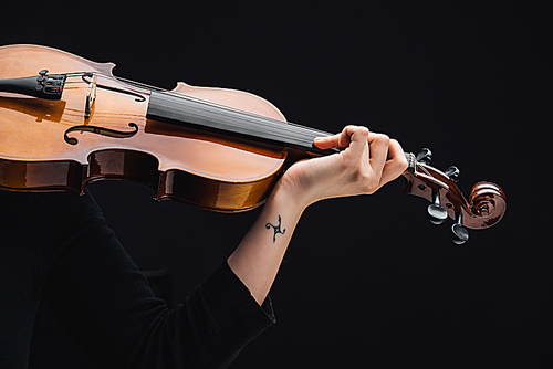 partial view of woman with tattoo playing cello isolated on black