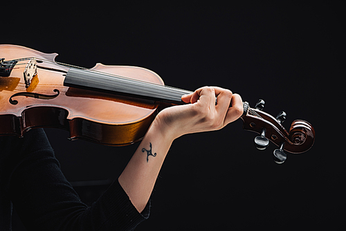 cropped view of woman with tattoo playing cello isolated on black