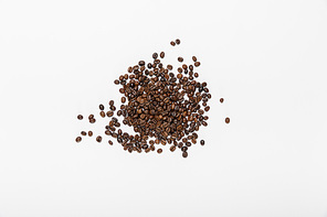 top view of scattered coffee grains on white background