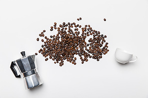 top view of aluminium coffee pot, coffee grains and cup on white background