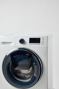 Modern washing machine with black display isolated on grey