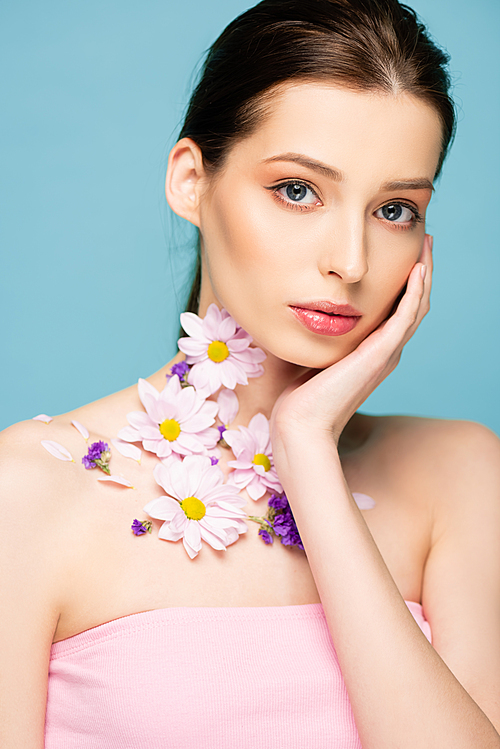 young woman with flowers on neck  isolated on blue