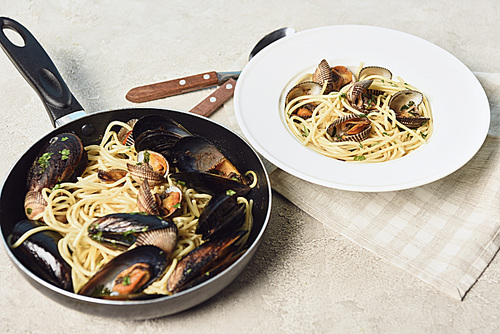 italian delicious pasta with seafood on textured grey background