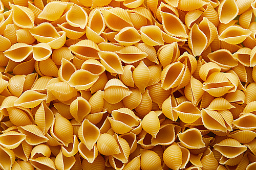 top view of raw Conchiglie seamless background