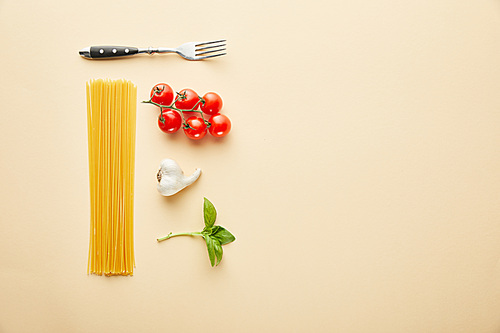 flat lay with delicious spaghetti with tomato sauce ingredients on yellow background