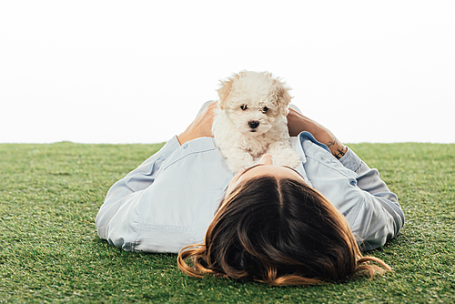 woman lying on grass with Havanese puppy isolated on white