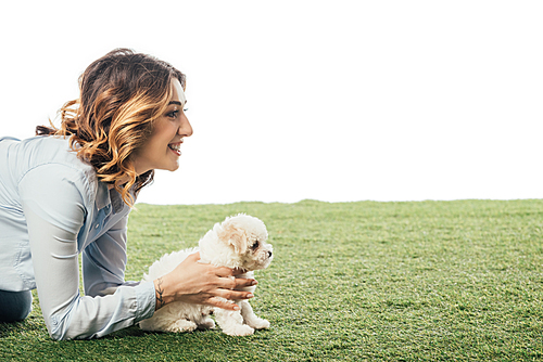 side view of smiling woman holding Havanese puppy isolated on white