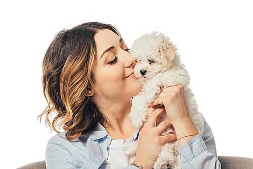 smiling woman holding cute Havanese puppy isolated on white