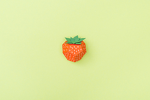 top view of handmade paper strawberry isolated on green