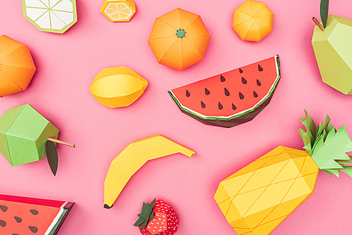 top view of handmade colorful origami fruits on pink