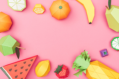 top view of handmade colorful origami fruits on pink with copy space