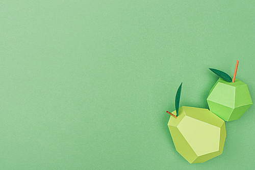 top view of handmade paper apple and pear isolated on green with copy space