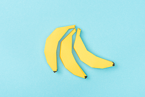 top view of yellow paper bananas Isolated On Blue