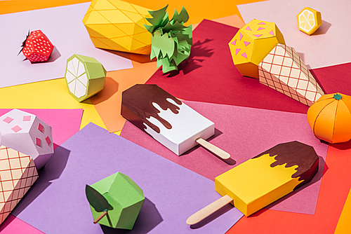 origami ice cream and handmade cardboard fruits on multicolored paper