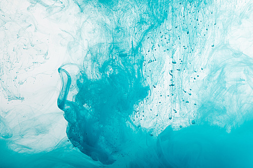 Close up view of blue paint swirls in water