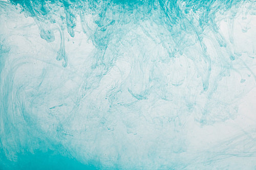 Close up view of light blue paint swirls in water