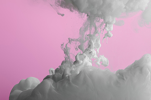 Close up view of acrylic white paint splash isolated on pink