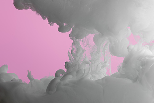 Close up view of artistic white paint swirls isolated on pink