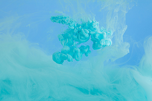 Close up view of turquoise smoky paint isolated on blue