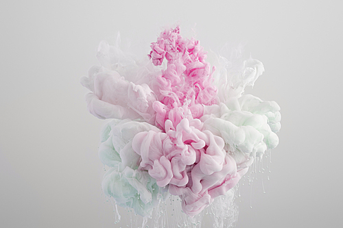 Close up view of blue, white and pink paint splash isolated on grey