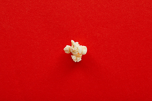 top view of sweet popcorn on red background