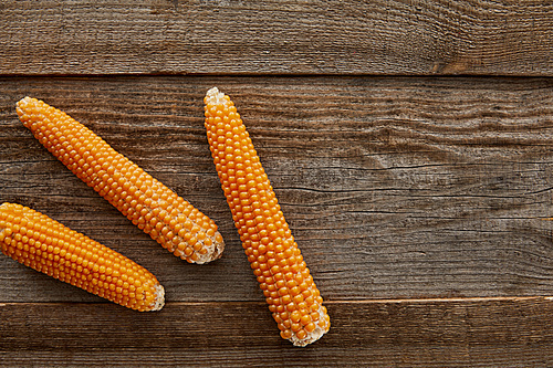 top view of delicious corn on wooden background