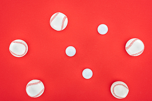 top view of white and leather softballs isolated on red