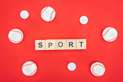 sport lettering on wooden cubes near softballs isolated on red