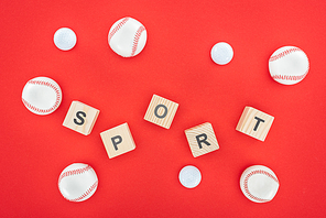 sport letters on wooden cubes near softballs isolated on red