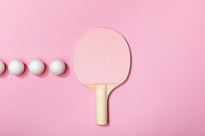 flat lay with table tennis balls and racket on pink background