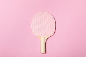 top view of table tennis pink wooden racket on pink background