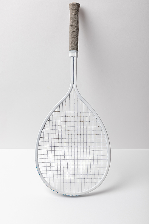 white simple plastic badminton racket on white background