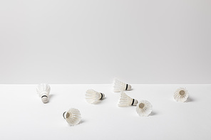 white badminton shuttlecocks scattered on white background