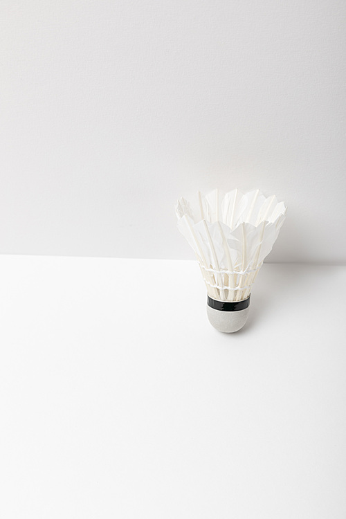 white light badminton shuttlecock on white background with copy space
