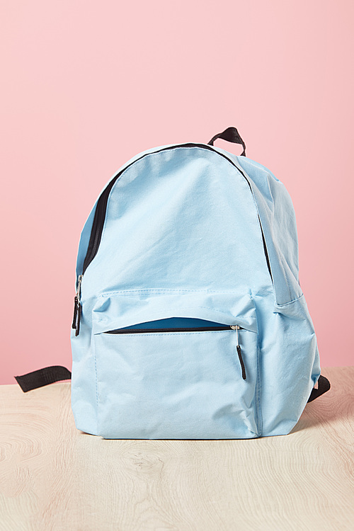 empty school blue backpack isolated on pink