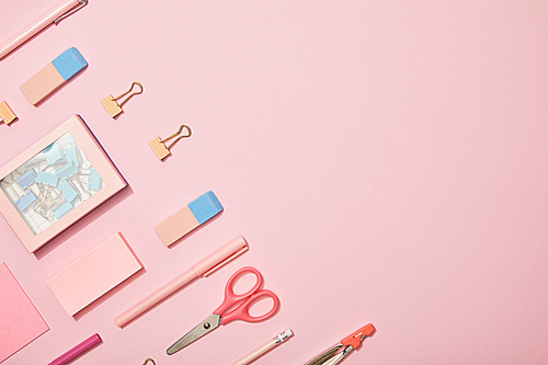 flat lay with pink school supplies isolated on pink with copy space