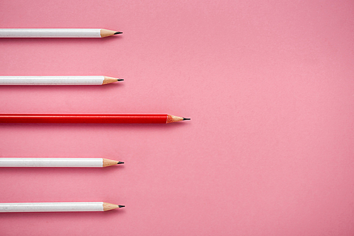 top view of sharpened white and red pencils isolated on pink
