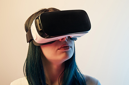 brunette woman wearing virtual reality headset on beige