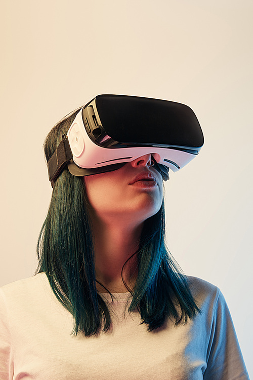 young woman in  white t-shirt wearing virtual reality headset on beige