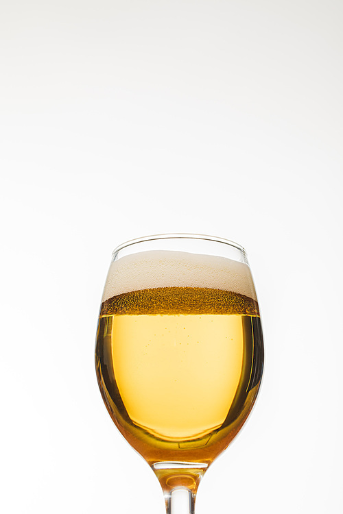 low angle view of glass of beer with bubbles isolated on white
