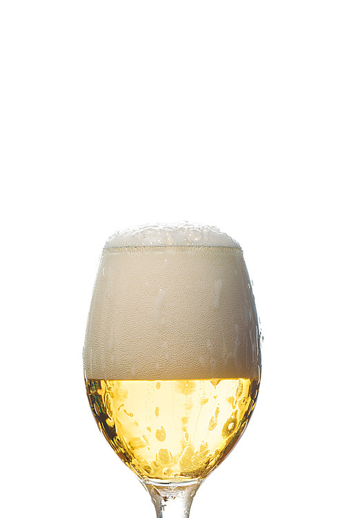wet glass of beer with white foam isolated on white