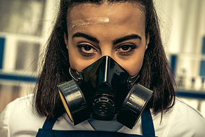 young girl laboratory technician in personal protective equipment, chemical lab