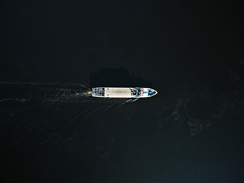aerial view of excursion boat with passengers on river